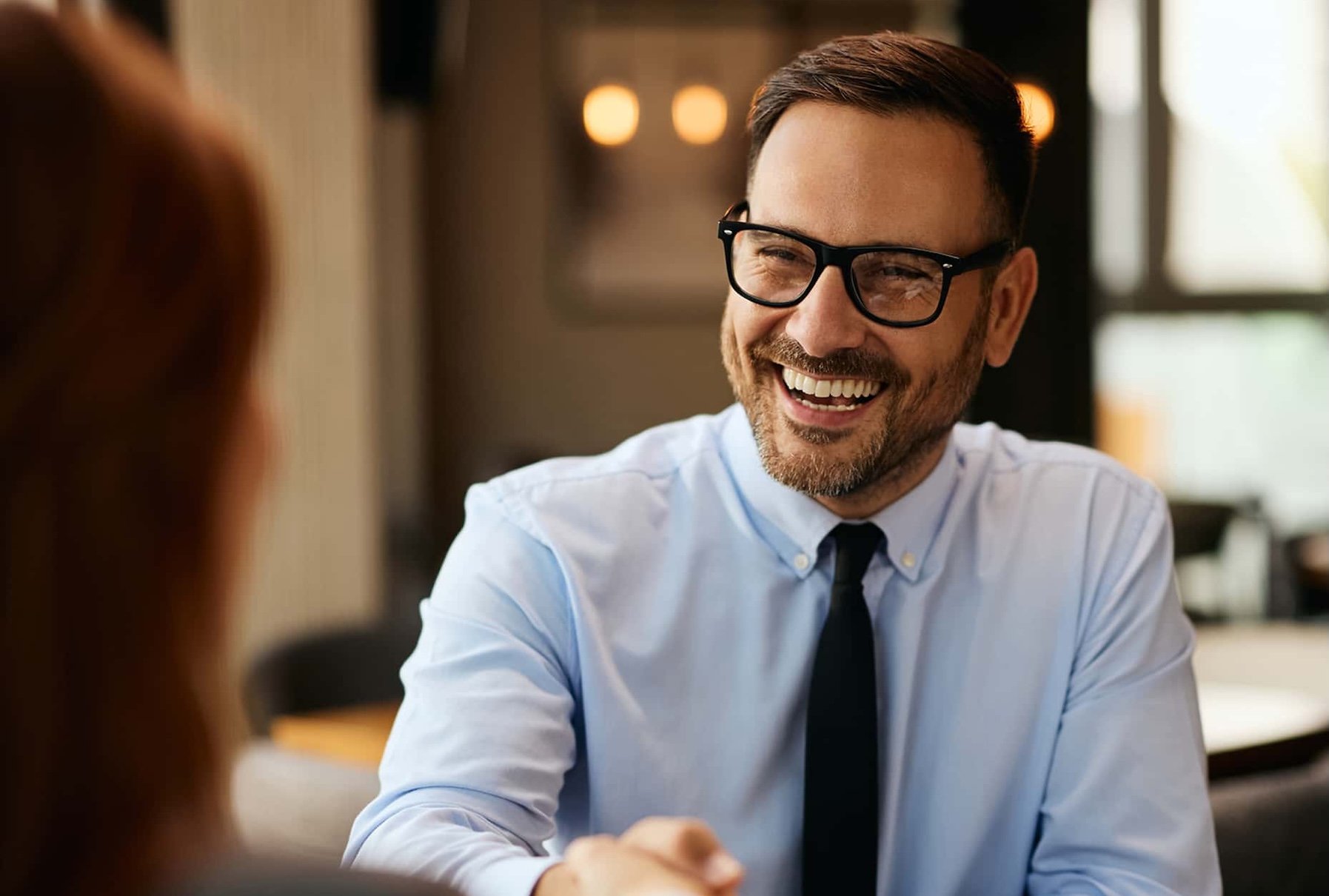 happy-insurance-brokers-reviewing-employee-benefits-options-with-an-ebrm-representative-in-a-modern-office-representing-partnership-and-dedicated-broker-support-1-1